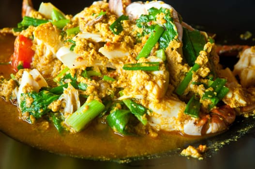Thai style yellow curry chilli crab stir-fried seafood dish with fresh spring onions