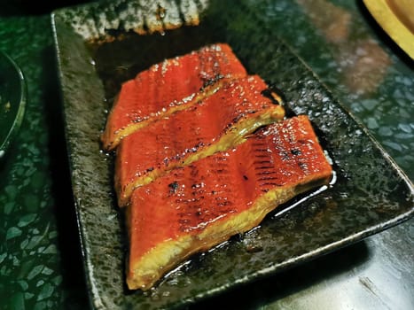 Unagi grilled Japanese eel pieces marinated in sweet black sauce