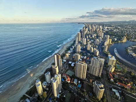 GOLD COAST, AUSTRALIA - APRIL 25, 2021: Aerial panorama view of High-rise building sky scrapers in Surfer Paradise beach city skyline landscape with Sunset light in the evening.
