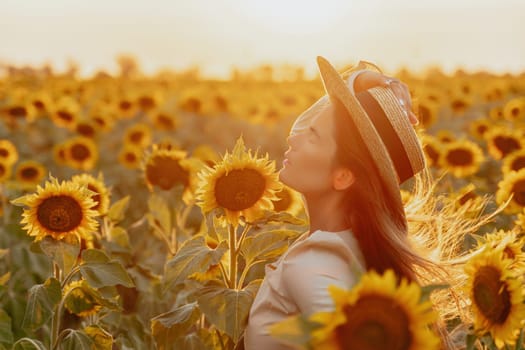 Woman in the sunflowers field. Summer time. Young beautiful woman standing in sunflower field.