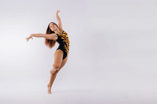 Full length portrait of plump woman doing physical exercise, jump, white and black background.