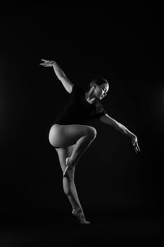 Full length portrait of plump woman doing physical exercise, jump, white and black background.