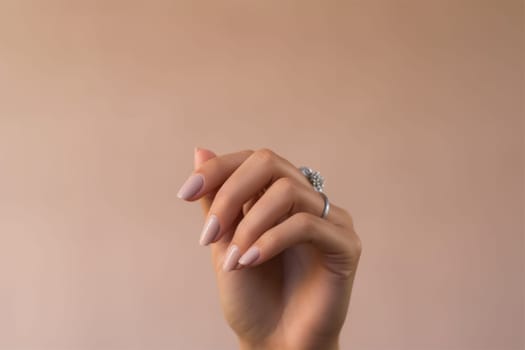 Closeup of woman hand with nude manicure. AI Generated