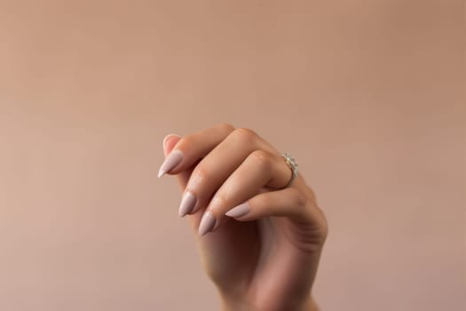 Closeup of woman hand with nude manicure. AI Generated