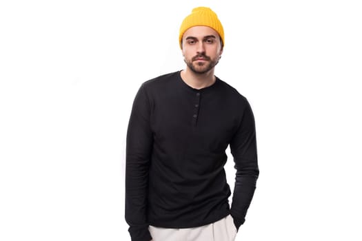 handsome 30s authentic brunet male adult in black sweatshirt posing as model on white background with copy space.