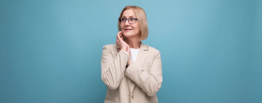 cheerful middle aged business woman on bright studio background with copy space.