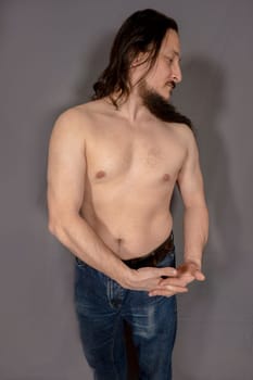 Young confident muscular man. A young man studio portrait.