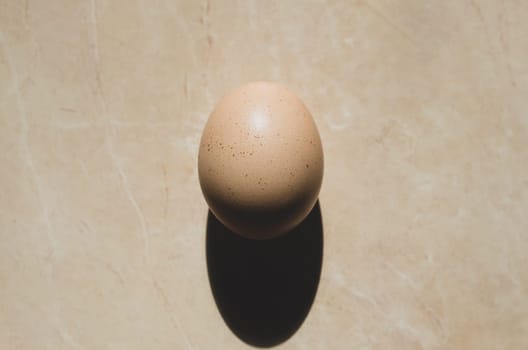 Close-up chicken egg. One yellow egg. top view