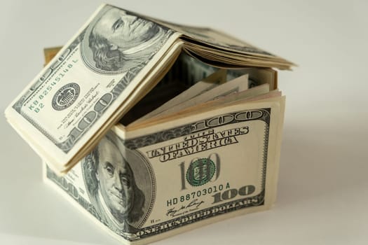 Mini house of dollars banknote. Concept of Investment property, Mortgage concept. Investment risk and uncertainty in the real estate housing market.