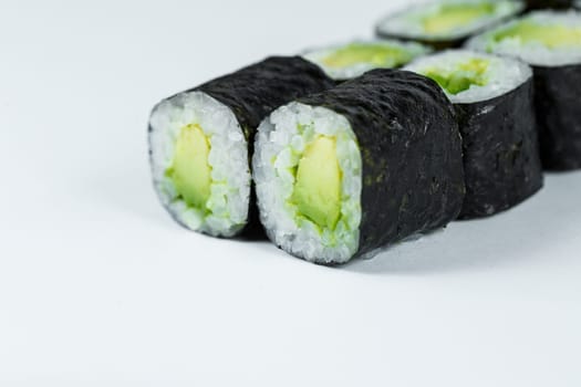 Japanese food. Rolls with ripe avocado, fresh rice with vegetables in nori. Vegetarian rolls