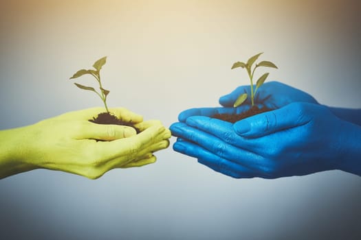 We have the same ideas. unrecognizable people holding budding plants in their colorful hands