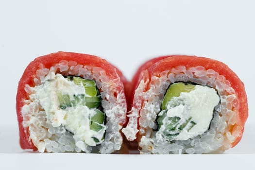 Japanese traditional food. Philadelphia sushi rolls with fresh avocado caviar and cream cheese and smoked salmon