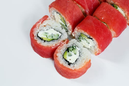 Japanese traditional food. Philadelphia sushi rolls with fresh avocado caviar and cream cheese and smoked salmon