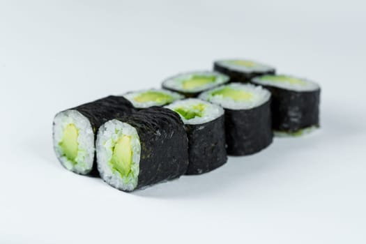 Japanese food. Rolls with ripe avocado, fresh rice with vegetables in nori. Vegetarian rolls