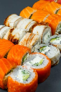 Japanese traditional food. Set of sushi rolls philadelphia with fresh salmon avocado and cream cheese and soy sauce