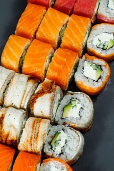 Japanese traditional food. Set of sushi rolls philadelphia with fresh salmon avocado and cream cheese and soy sauce