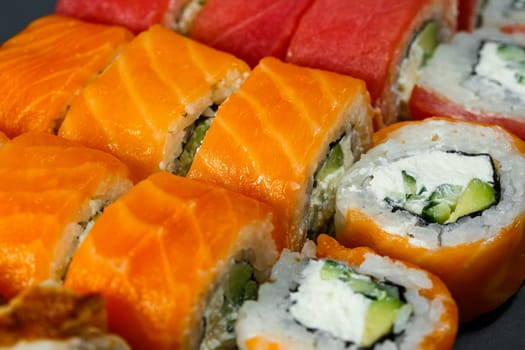Japanese traditional food. Set of sushi rolls philadelphia with fresh salmon avocado and cream cheese and soy sauce