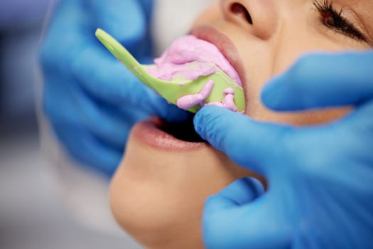 Finding the perfect fit. a young woman having dental work done on her teeth