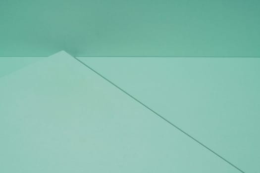 Colorful background from green paper with shadow. Abstract geometric