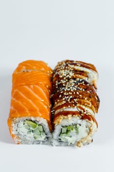 Sushi assorted. Sushi roll with avocado, cucumber. Sushi roll with salmon and caviar. Sushi roll with tuna and caviar. On a light background. Japanese food. View from above