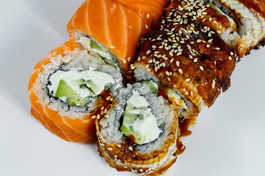 Sushi assorted. Sushi roll with avocado, cucumber. Sushi roll with salmon and caviar. Sushi roll with tuna and caviar. On a light background. Japanese food. View from above