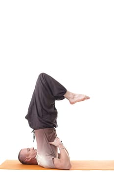 Side view of sporty man posing in difficult asana, isolated over white background