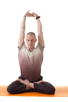 Image of middle-aged man posing in lotus posture, isolated on white