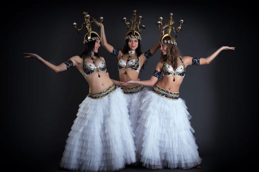 Pretty young girls dancing with chandeliers in studio