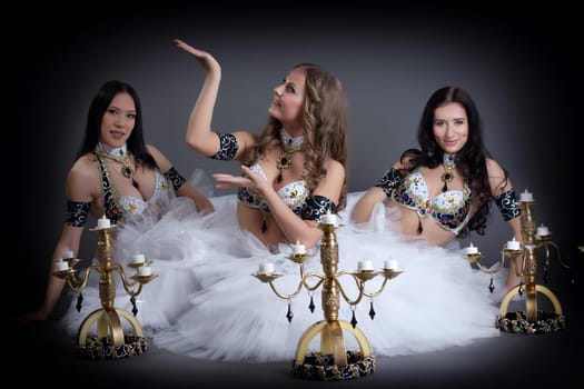 Image of charming belly dancers posing with chandeliers