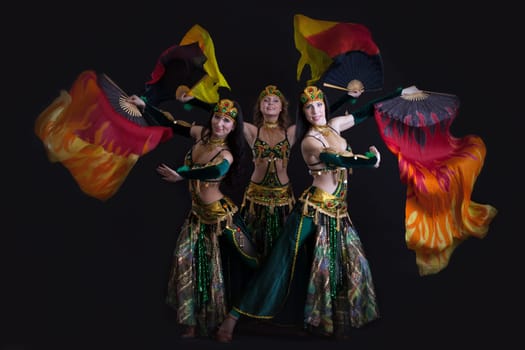 Image of young graceful oriental dance performers posing in studio