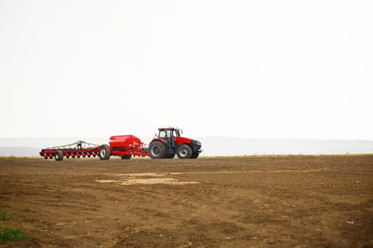 Large modern tractor for preparing the field after winter for sowing grain. Agricultural machinery