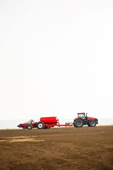 Large modern tractor for preparing the field after winter for sowing grain. Agricultural machinery