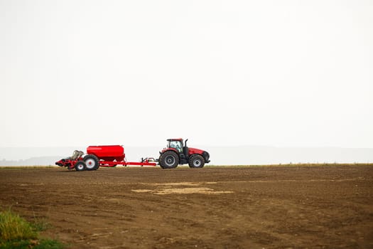 Large modern tractor for preparing the field after winter for sowing grain. Agricultural machinery