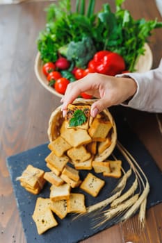 Slices of toasted bread and pate in female hands. Fresh croutons made of whole grain flour