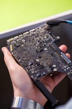 Professional computer and tablet repair shop or service. Close up of a computer board. Electronics concept. Detail from a laptop under repair