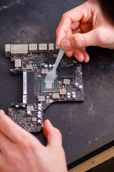Professional computer and tablet repair shop or service. Close up of a computer board. Electronics concept. Detail from a laptop under repair