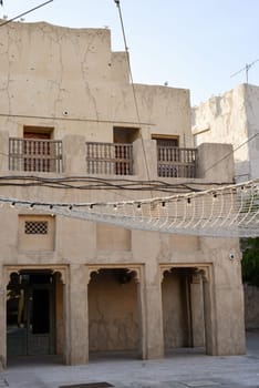 Narrow streets that create shade on a hot day in the old city of Dubai Creek and Bur district. Travel destinations and heritage village.