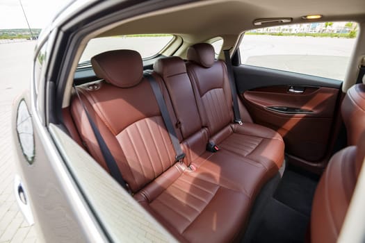 Brown leather seats in the new car. Interior upholstery with genuine leather.