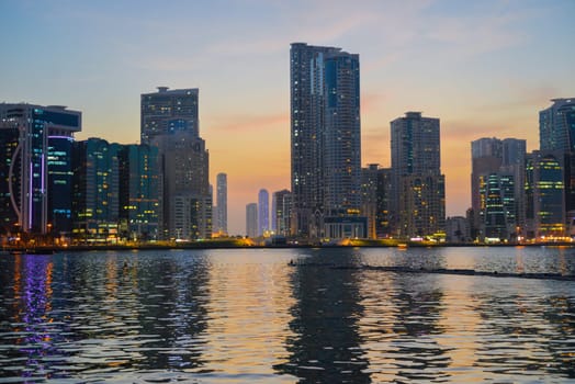 Night landscape of the embankment of the emirate of Sharjah, United Arab Emirates