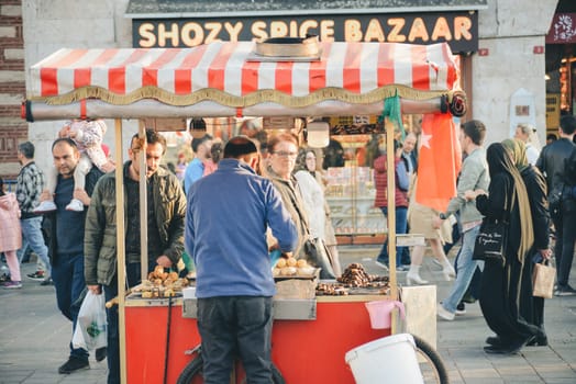 Istanbul, Turkey - May 02, 2023: Seller of roasted chestnuts and corn on the street in Istanbul