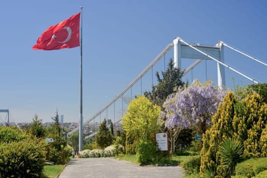 Istanbul, Turkey, May 02, 2023: View of Istanbul from Otagtepe with the Fatih Sultan Mehmet Bridge and flag waving in the wind. Travel Istanbul background photo