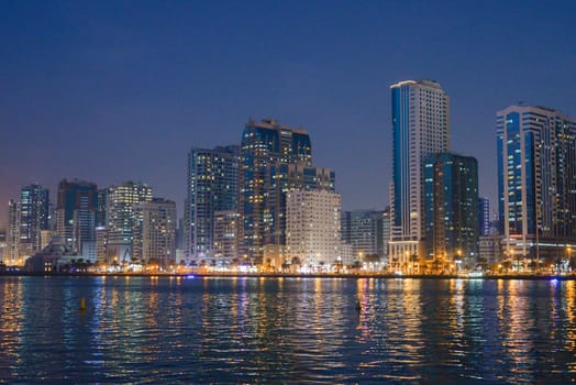 Night landscape of the embankment of the emirate of Sharjah, United Arab Emirates