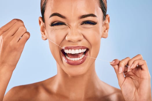 Happy woman, portrait and flossing teeth in dental, clean hygiene or healthcare against a studio background. Female person or model with smile in tooth whitening, floss or oral, gum or mouth cleaning.
