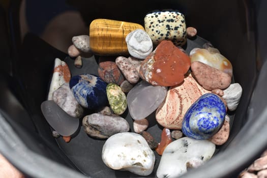 Rock Tumbler Barrel Full of Assorted Polished Stones on Step 3 Grit . High quality photo