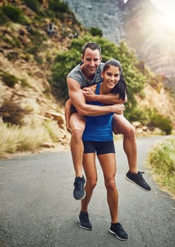 Im her weights. a young attractive couple training for a marathon outdoors