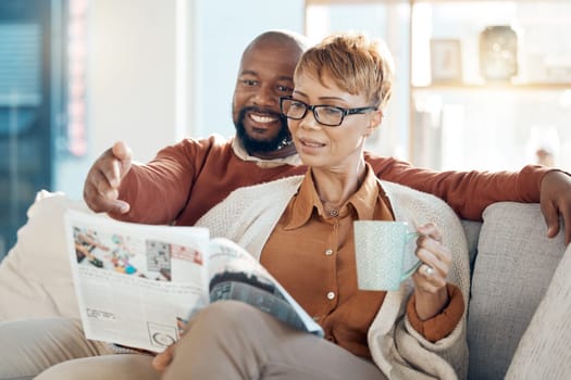Couple, bonding or reading magazine on sofa in house or home living room for travel ideas, holiday planning or vacation location planning. Happy smile, mature black woman and man with books or coffee.