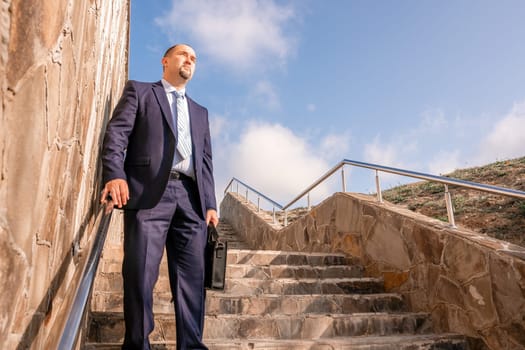 Business executive with briefcase going down the stairs.