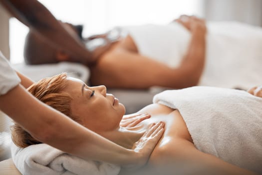 Massage, relax and couple at a spa for luxury skincare, wellness and therapy for body. Stress relief, health and man and woman with hands from hotel employees for a relaxation treatment at a salon.