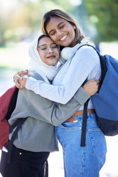 Islamic students, backpack or hug in park, garden or school campus for bonding, friends acceptance or community support. Smile, happy or Muslim women in embrace, fashion hijab or university college.