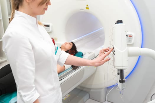 Female patient undergoing MRI - Magnetic resonance imaging in Hospital. Medical Equipment and Health Care.